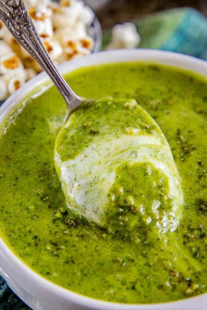 Bowl of creamy zucchini soup topped with popcorn