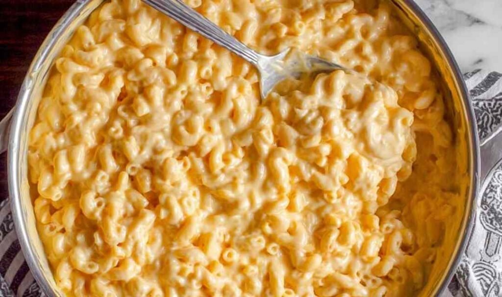 Easy stovetop mac and cheese in a skillet with a creamy sharp cheddar sauce coating the elbow macaroni