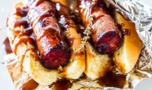 JDawgs special sauce copycat hot dogs served in buttered toasted buns with sweet tangy sauce drizzled on top