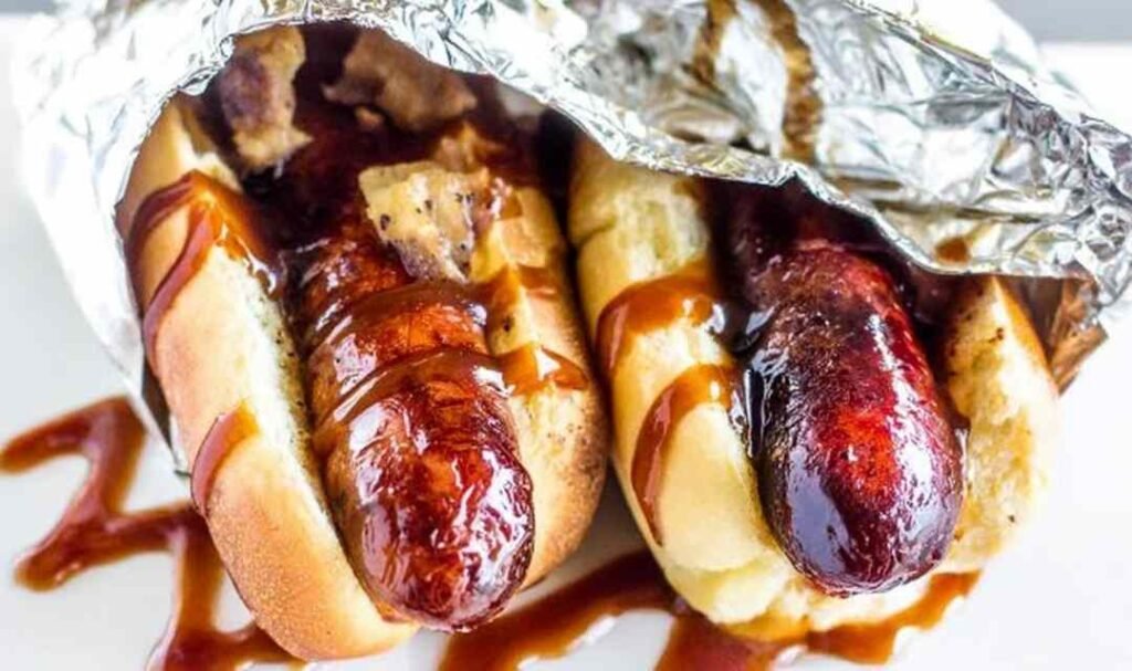 JDawgs special sauce copycat hot dogs served in buttered toasted buns with sweet tangy sauce drizzled on top