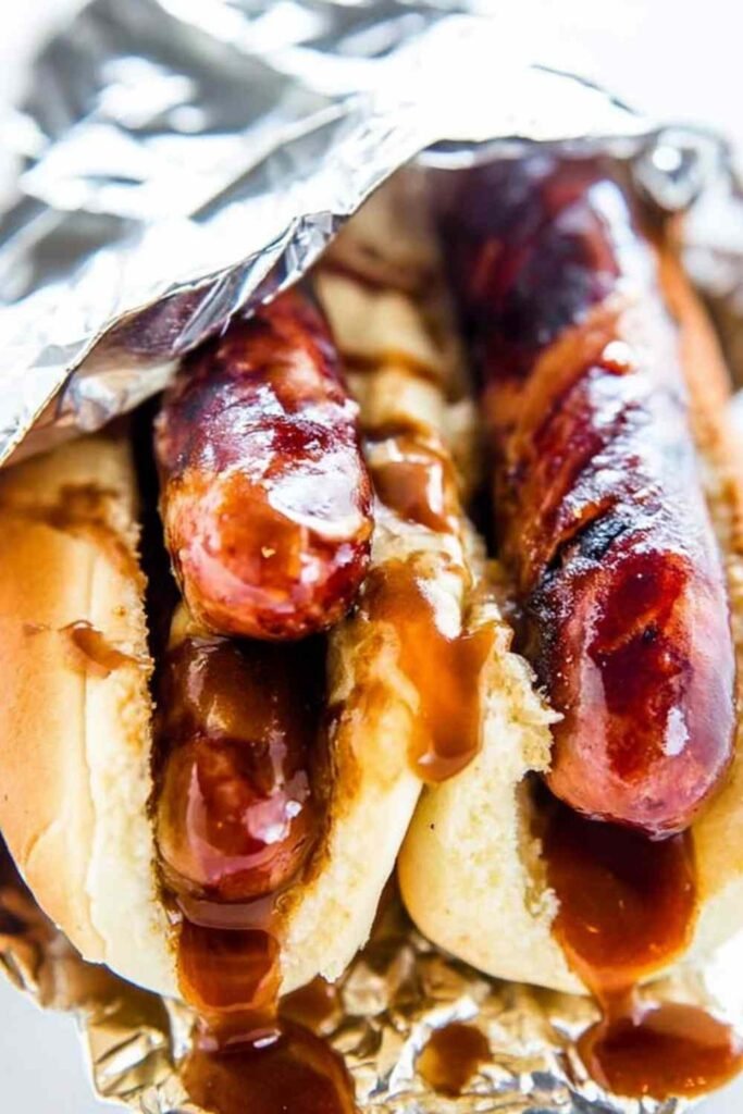 JDawgs special sauce copycat hot dogs served in buttered toasted buns with sweet tangy sauce drizzled on top