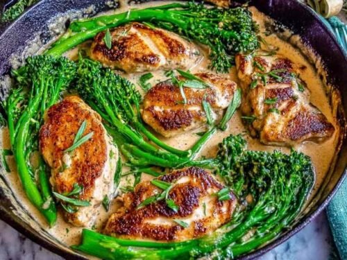 Bacon wrapped hot dogs grilling over low heat with crispy golden bacon on an outdoor grill