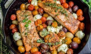 Pan-seared salmon with cherry tomatoe Pan-seared salmon with cherry tomatoes and mozzarella in a cast iron skillet