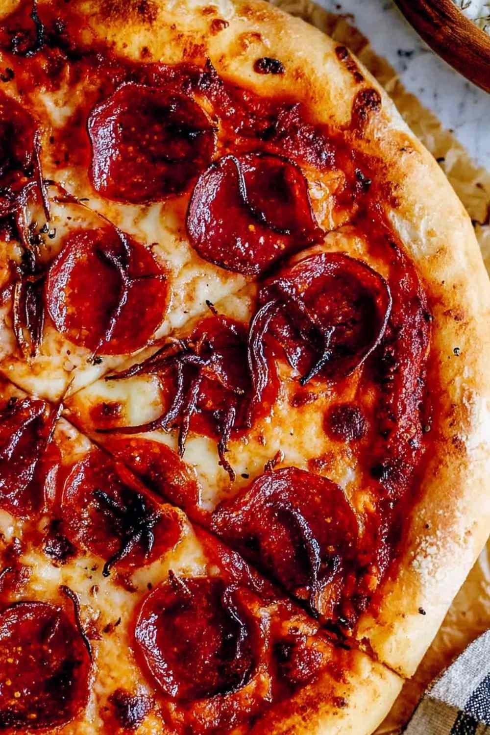 Hands kneading a smooth pizza dough recipe in a bowl.