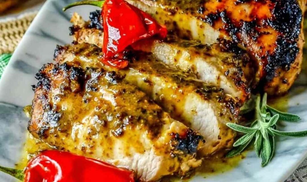 Bone-in slow grilled mustard chicken cooking over indirect heat on a gas grill