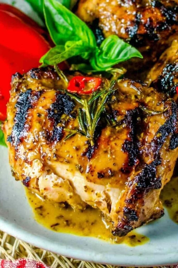 Bone-in slow grilled mustard chicken cooking over indirect heat on a gas grill