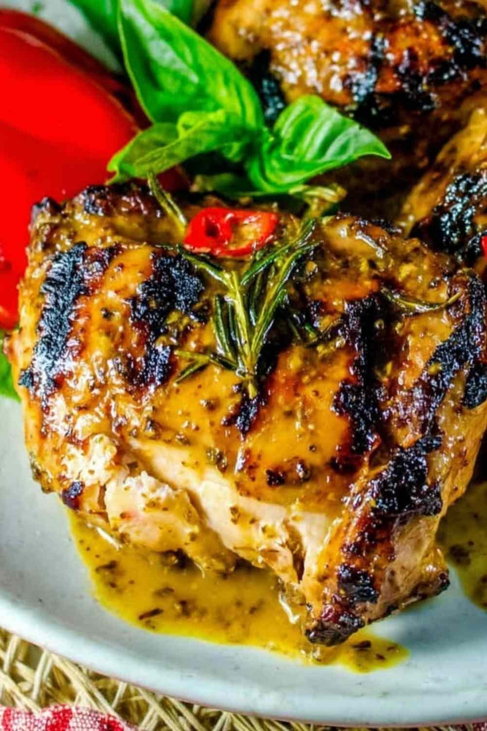 Bone-in slow grilled mustard chicken cooking over indirect heat on a gas grill