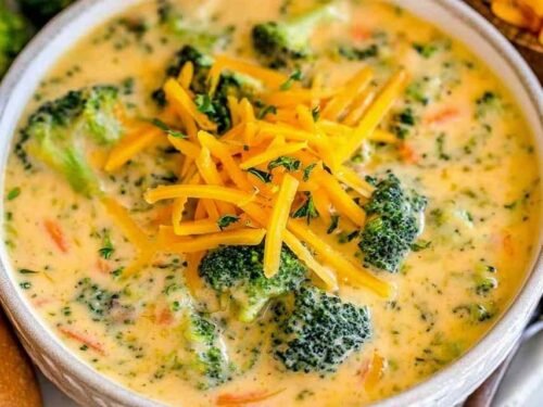 Bowl of easy broccoli cheese soup topped with cheddar