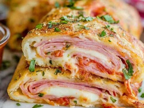 Easy Stromboli recipe dough rolled with ham and cheese