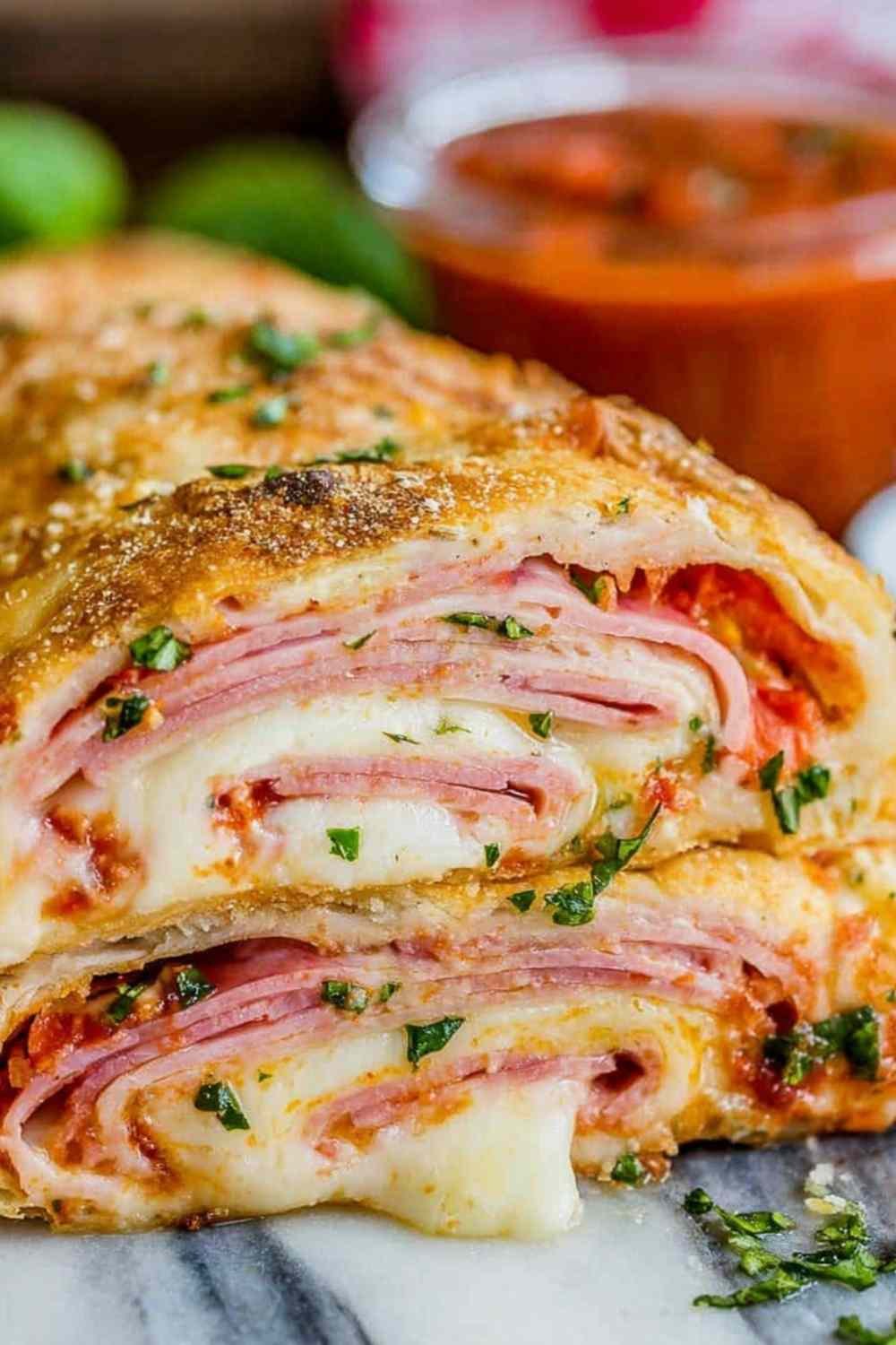 Easy Stromboli recipe dough rolled with ham and cheese