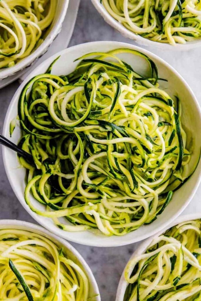 How to make zoodles — sautéed zucchini noodles in a skillet with garlic and Parmesan cheese