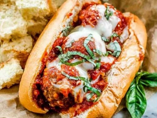 Ingredients for an easy meatball sub recipe including diced onions and canned tomatoes.